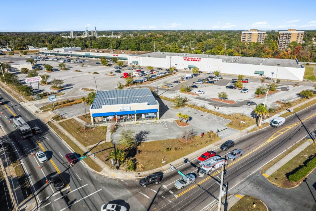 Aerial view of Norwood Plaza Flea Market in Jacksonville, showcasing various vendor stalls and shoppers.