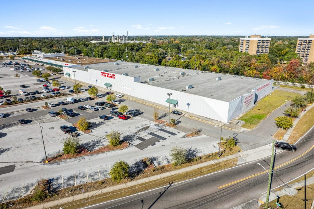 Exterior view of Norwood Plaza Flea Market in Jacksonville, featuring a large sign and parking area.