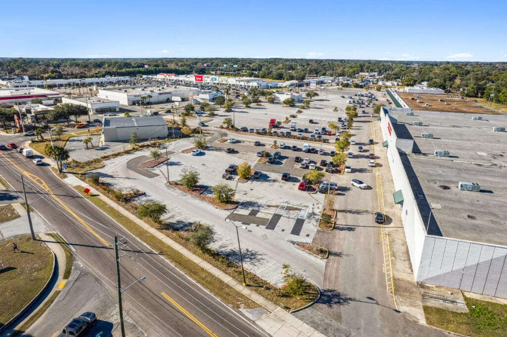Exterior view of Norwood Plaza Flea Market in Jacksonville, featuring a large sign and parking area.