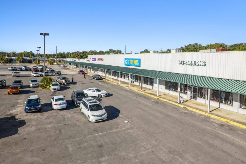 Exterior view of Norwood Plaza Flea Market in Jacksonville, showcasing various vendor stalls and signage.