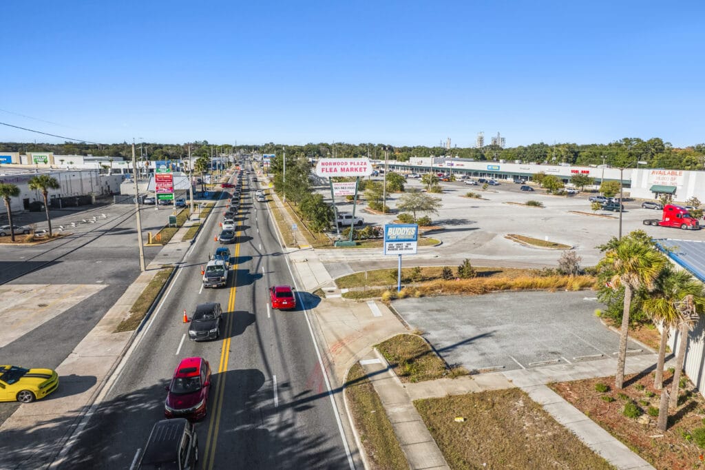 Exterior view of Norwood Plaza Flea Market in Jacksonville, featuring a large sign and parking area.