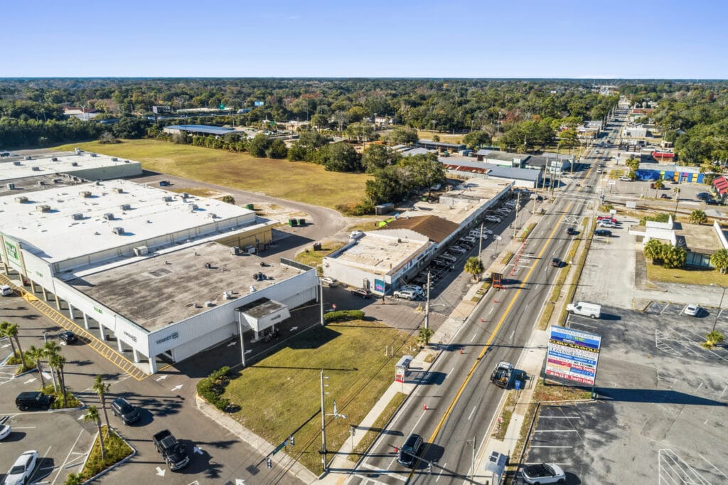 Exterior view of 5848 Norwood Ave in Jacksonville, showcasing a commercial strip mall with parking.