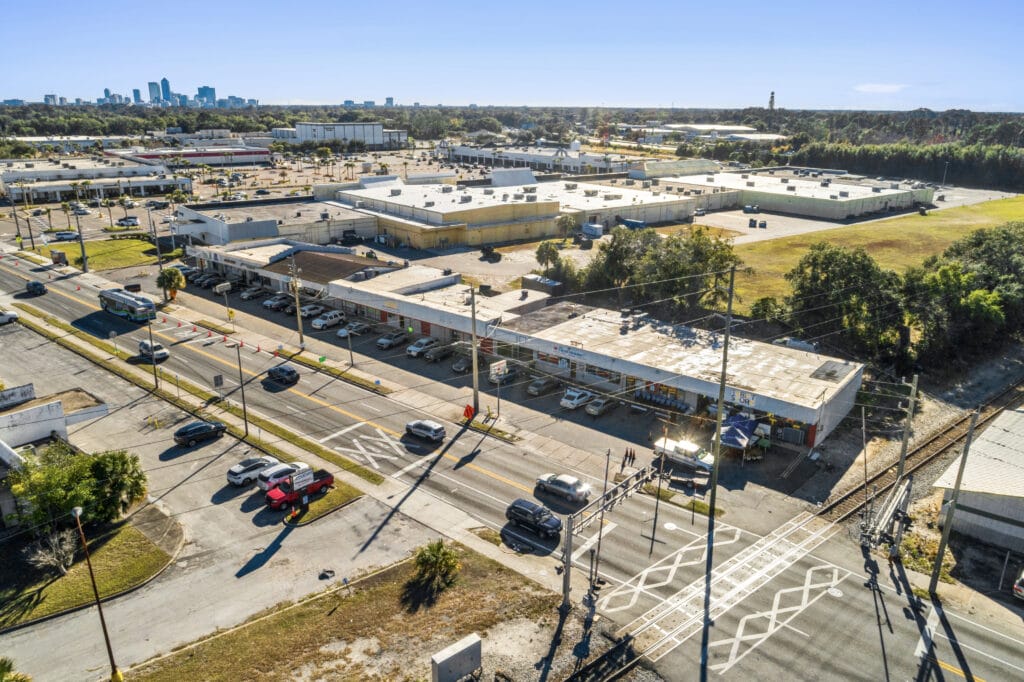 Exterior view of 5848 Norwood Ave, a commercial property in Jacksonville, showcasing its signage and parking area.