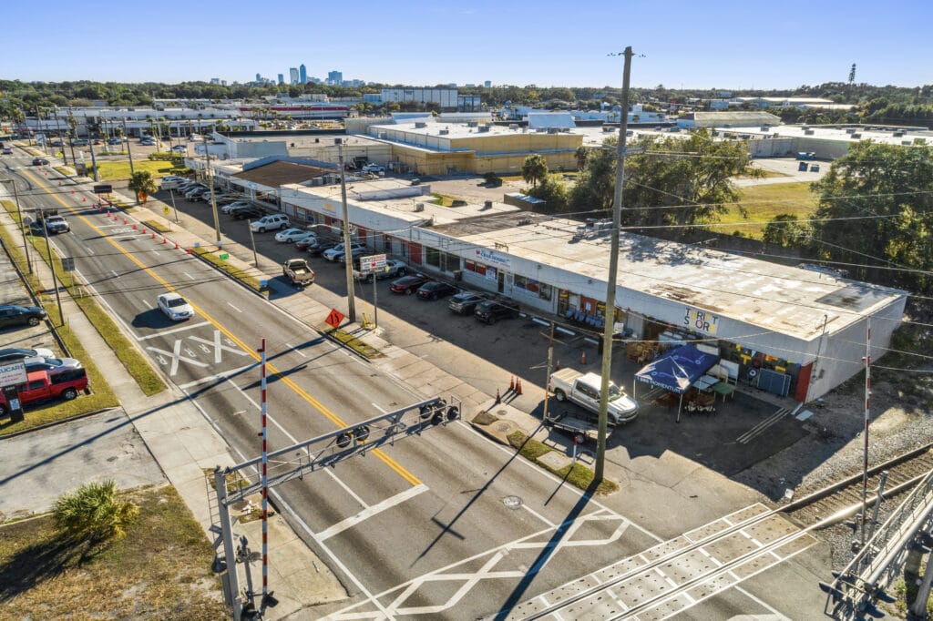 Exterior view of 5848 Norwood Ave, Jacksonville, showcasing the strip mall's signage and parking area.