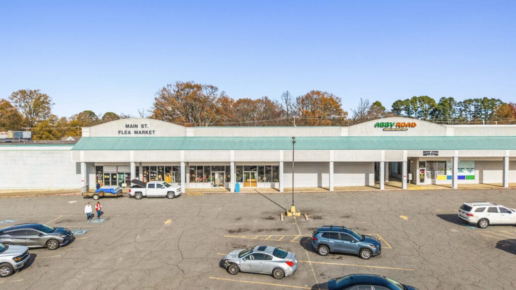Exterior view of a commercial building on W Main St, showcasing its modern architecture and signage.
