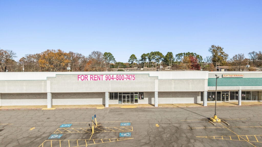 Exterior view of a commercial property on W Main St in Jacksonville, AR, showcasing its architecture and surroundings.