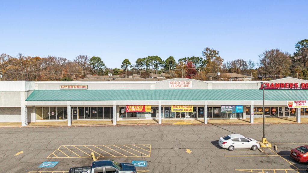 A spacious commercial property with a large parking lot and modern architecture on W Main St in Jacksonville, AR.