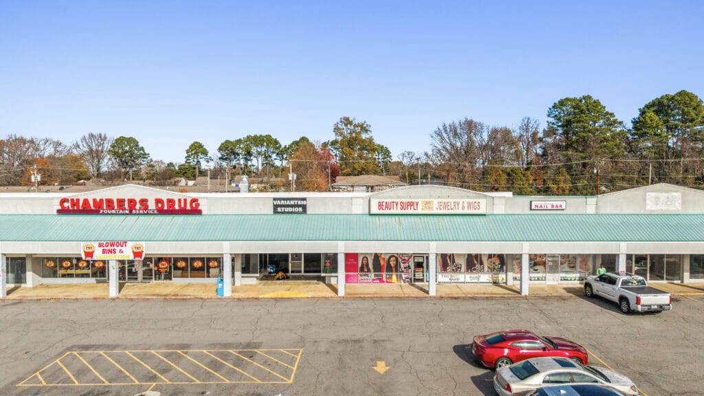 A large commercial building on W Main St, showcasing a modern facade and ample parking space in Jacksonville, AR.