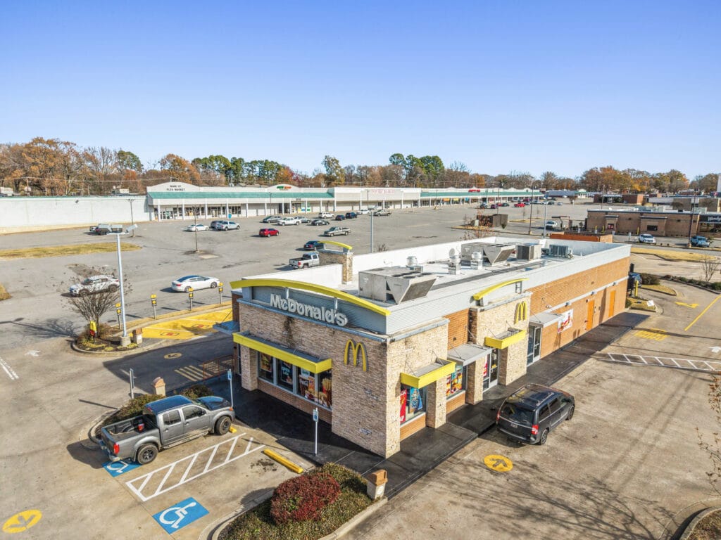 A spacious commercial property on W Main St in Jacksonville, AR, featuring a large parking lot and modern architecture.