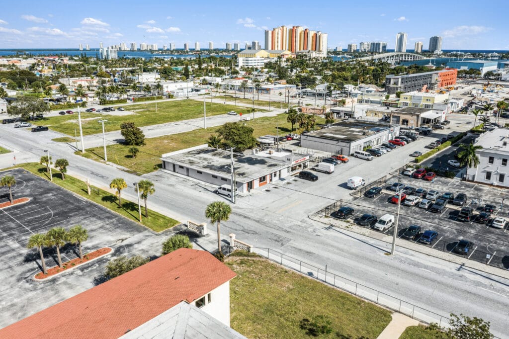 Exterior view of a residential property at 64 W 21st St, Riviera Beach, FL, showcasing its architecture and landscaping.