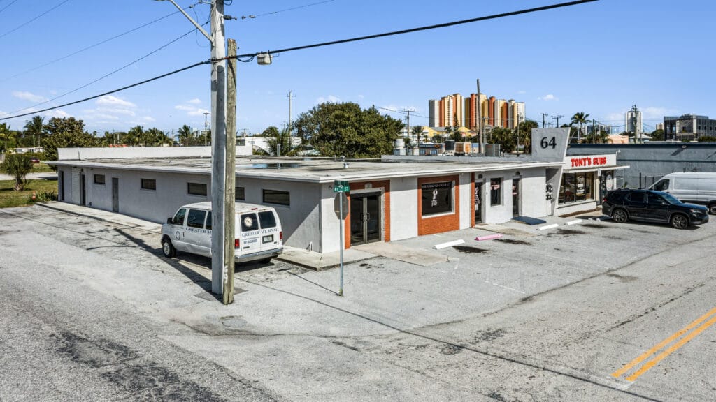 Exterior view of a residential property at 64 W 21st St, Riviera Beach, FL, showcasing the architecture and landscaping.