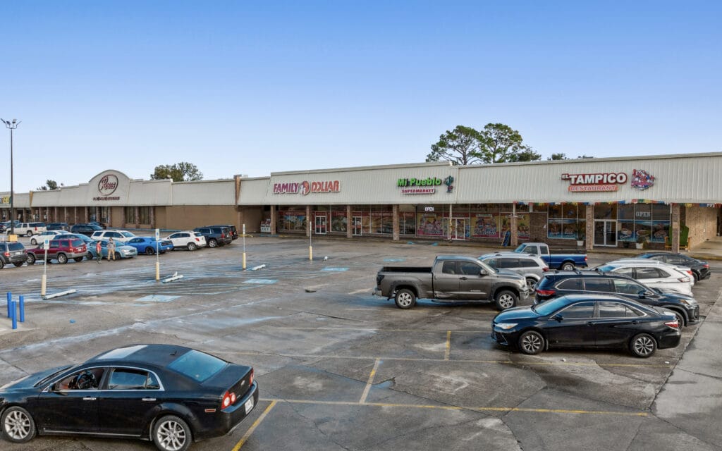 Exterior view of a large commercial property at 1221 Grand Caillou Rd, showcasing its architecture and surroundings.