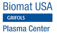 A cozy treatment room at Biomat USA featuring a comfortable bed, soothing decor, and wellness products.