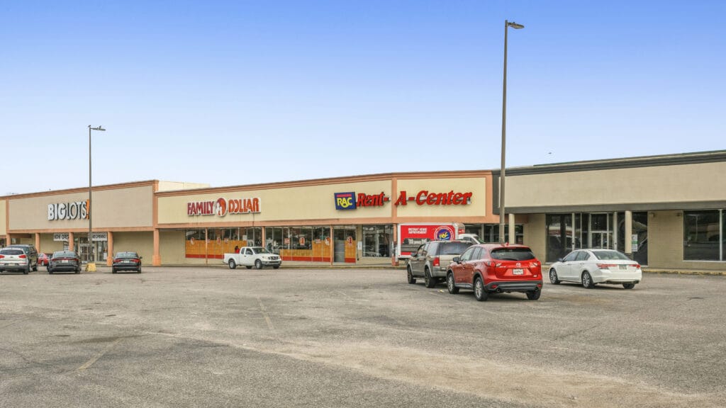 Two-story commercial buildings at 2704 and 2708 Peach Orchard Rd, featuring a brick facade and parking area.