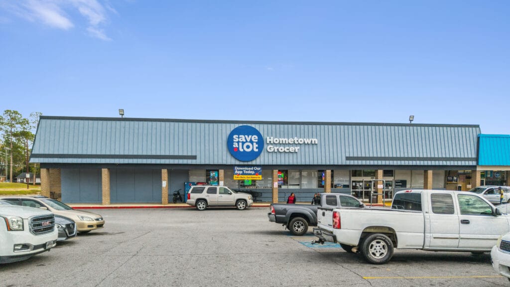 Exterior view of Moultrie Plaza, featuring a modern building with large windows and landscaping, located at 215 5th St SE, Mo