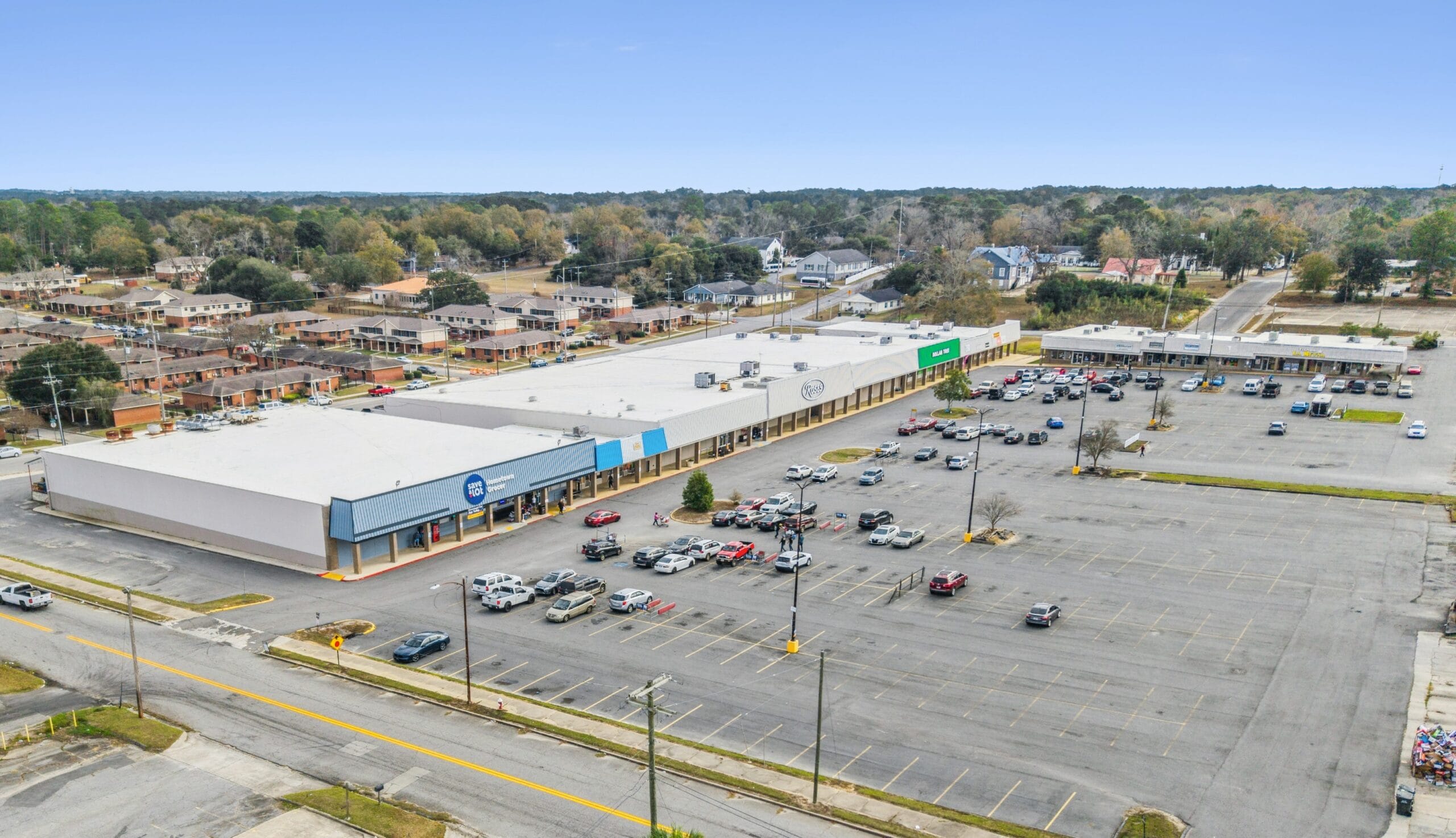 A modern commercial building with large glass windows and a welcoming entrance, showcasing Moultrie Plaza.