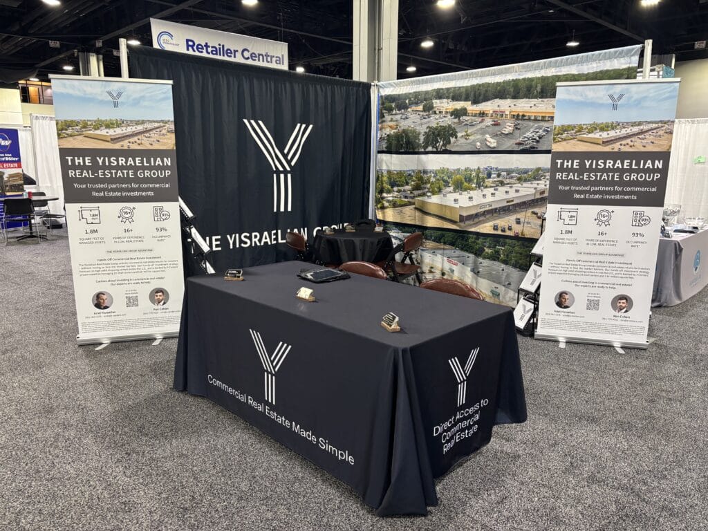 A conference scene at ICSC Atlanta, GA on 10-15-2025, showcasing attendees engaged in discussions.