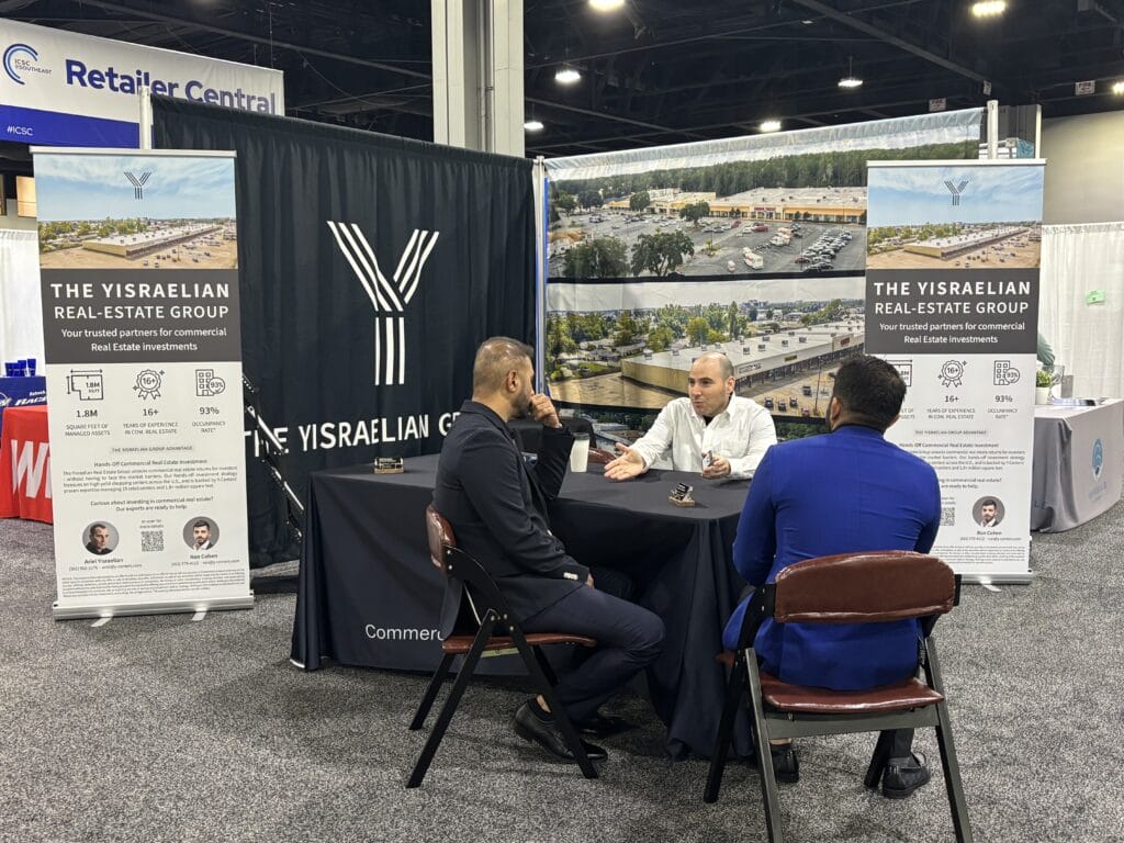 A conference scene at ICSC Atlanta, GA, showcasing attendees engaging in discussions and networking.