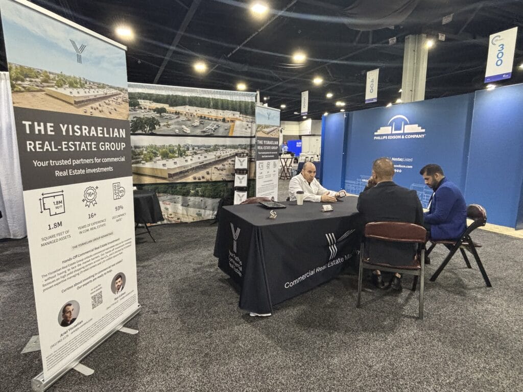 A conference setting at ICSC Atlanta, GA, showcasing attendees engaging in discussions and networking on 10-15-2025.