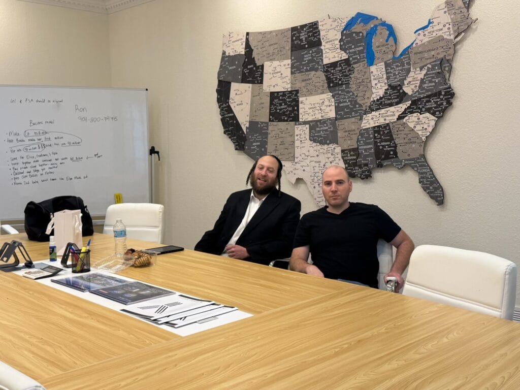 Group of Hasidic men engaged in a cooperative meeting in New York, discussing plans on February 19, 2026.