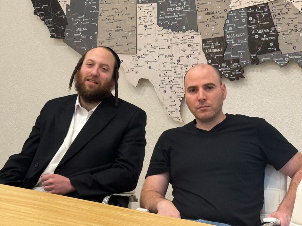 A group of Hasidic men engaged in a cooperation meeting in New York on February 19, 2026.